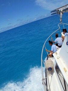 Clearwater Middle School students look out over the bow of a BIOS boat on their way out to North Rock Bermuda