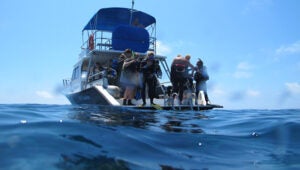 Students prepare to SCUBA dive in Bermuda off one of BIOS's small boats