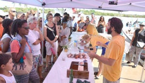 A scientist speaks to a crowd at the annual lionfish tournament