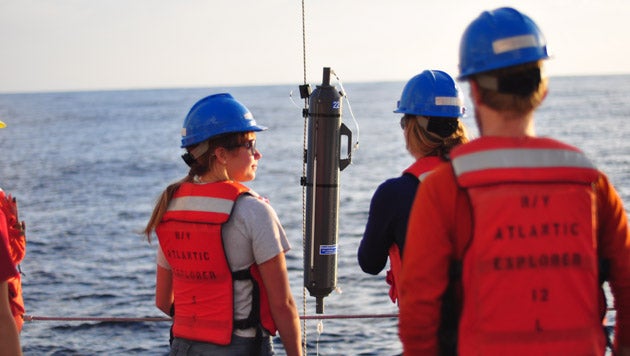 marine technicians work aboard a research vessel at sea